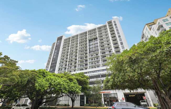 Luxury high-rise exterior of MB Station apartments in Miami's Coral Way neighborhood, offering modern studio, one-, and two-bedroom apartment homes near Brickell and Coral Gables.
