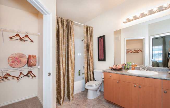 a bathroom with a shower curtain and a sink and a toilet