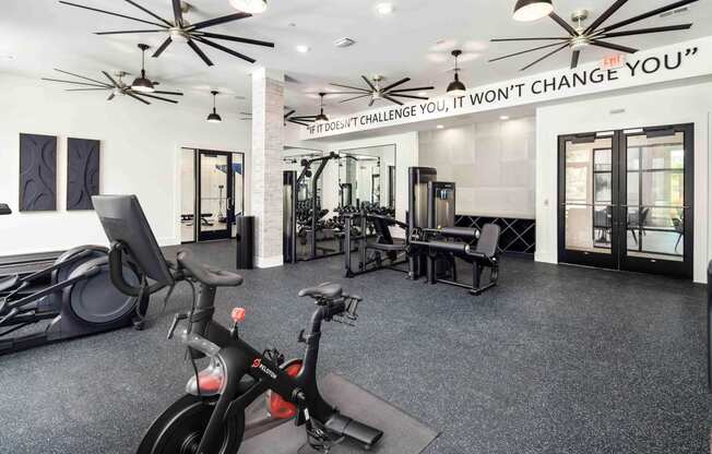 a home gym with exercise equipment and a sign that says weight change you
