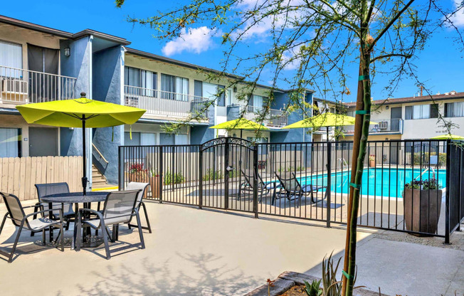 our apartments have a pool and a patio with tables and chairs