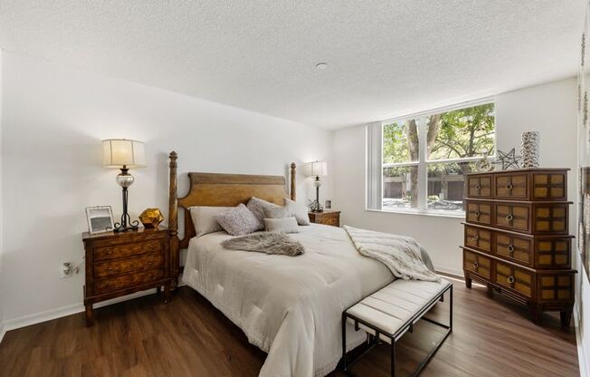 a bedroom with a bed and a window
