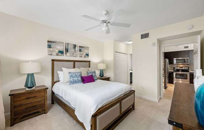 a bedroom with a large bed and a ceiling fan