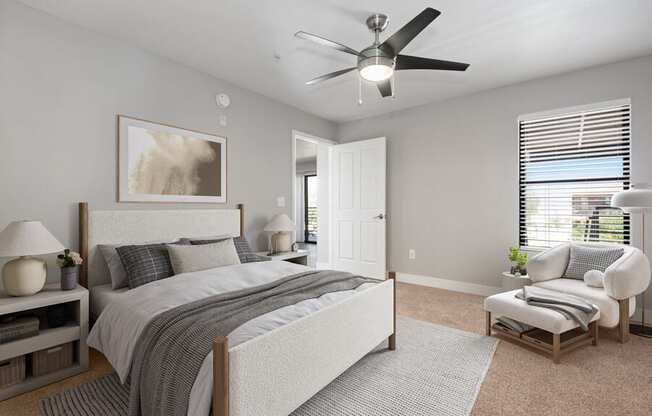 Model apartment bedroom with a bed and a ceiling fan at Harmony at Surprise, Surprise, Arizona, 85379
