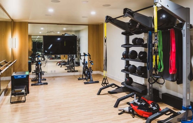 Fitness studio includes a space for yoga, barre, spinning, and TRX workouts