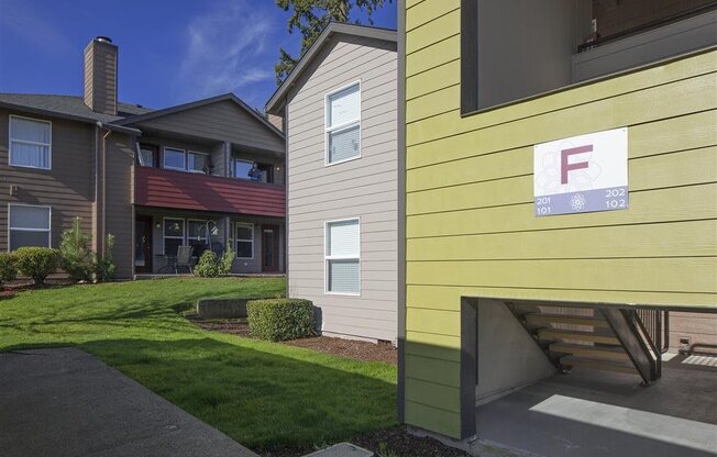 Canby, OR Apartments - Exterior View of Township Apartments Building Surrounded By Lush Landscaping with View of Outdoor Lounge