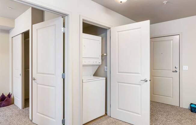 the closet in a bedroom of a home with white doors