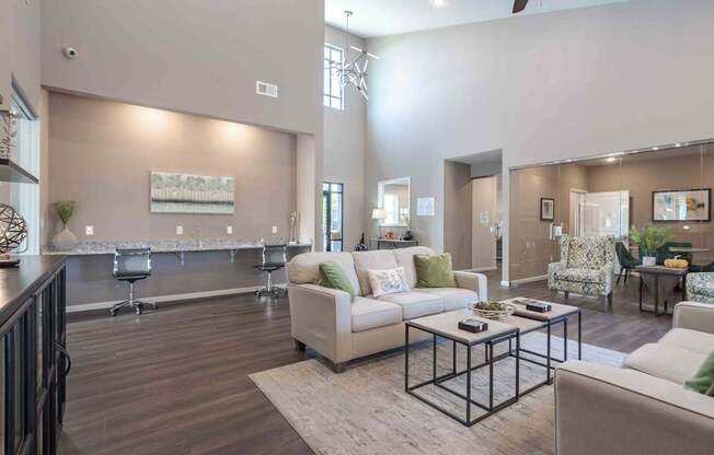 A spacious living room with a white sofa and a coffee table.
