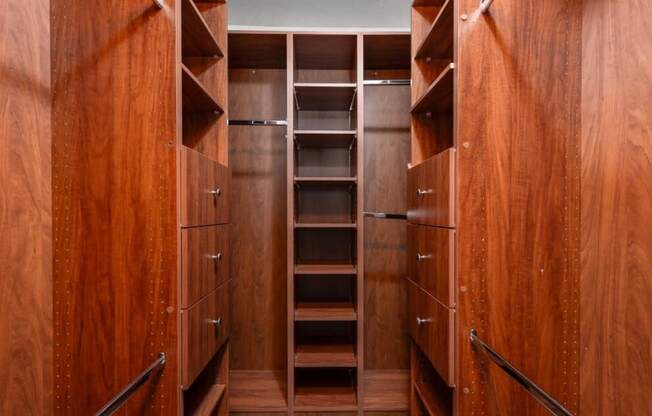 A series of wooden shelves and drawers in a room.