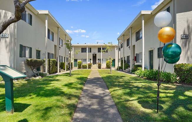 Beautiful Courtyard With Walking Paths at Colonial Garden Apartments, California