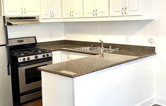 Open kitchen layout white cabinetry next to dining room  at Parc Meridien, California, 90020