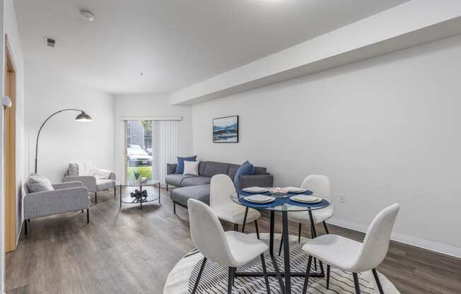 a living room with a couch and a table and chairs  at Shoreline Village, Richland, WA, 99352