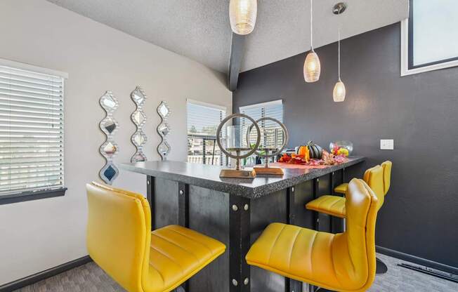 A kitchen with a table and chairs.