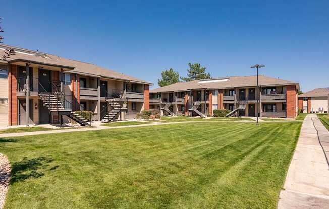 a row of apartments with balconies and a lawn