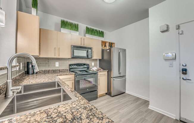 A kitchen with a stove top oven, microwave, and refrigerator.
