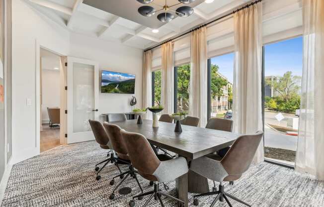 a dining room with a table and chairs and a large window