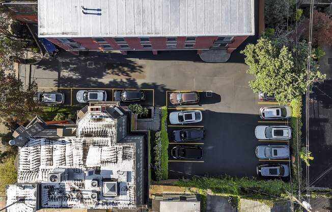 an aerial view of a building with cars parked in a parking lot