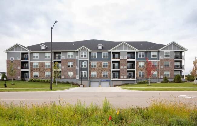 a large apartment building with a parking lot in front of it