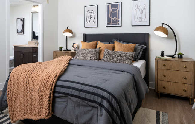 A bedroom with a large bed and a ceiling fan.