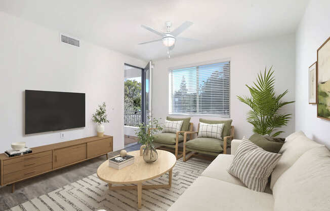 A living room with a flat screen TV, a coffee table, and a couch.