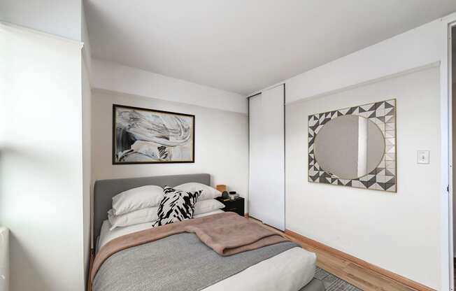 a bedroom with a large bed and a mirror on the wall