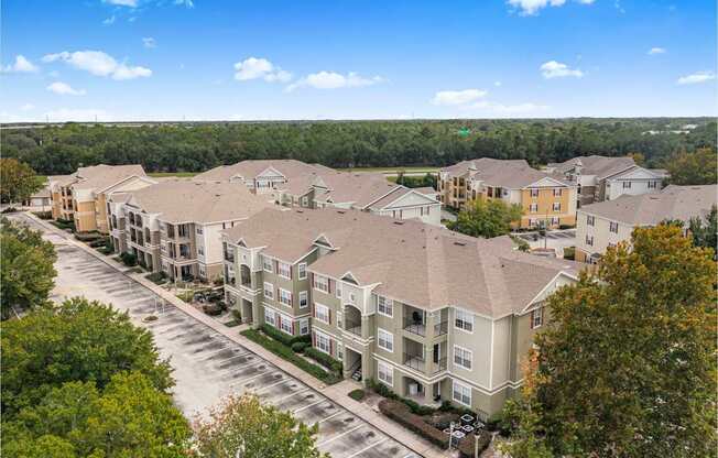 A large apartment complex with multiple buildings and a parking lot.