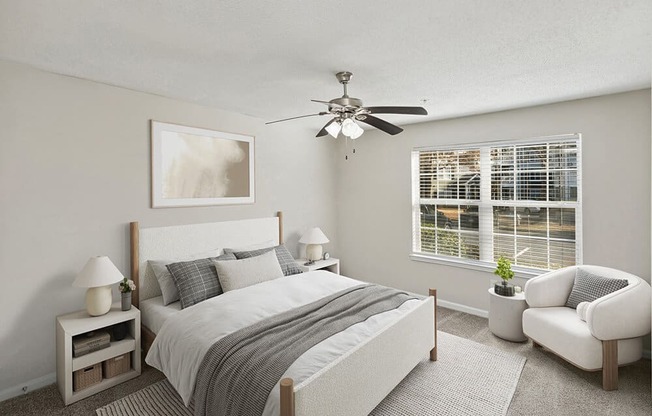 Model Bedroom with Carpet and Window View at Shadow Ridge Apartments in Riverdale, GA.