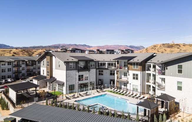 an aerial view of an apartment complex with a swimming pool