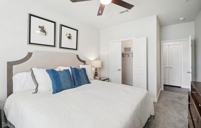 a bedroom with a large bed and a ceiling fan