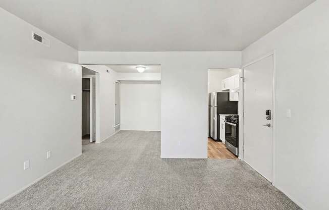A spacious, empty dining room with a breakfast bar at Trappers Cove Apartments, Lansing