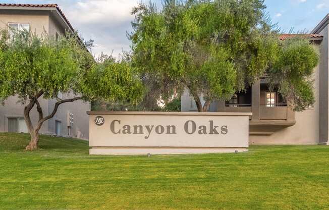 Canyon oaks community sign with lush landscape