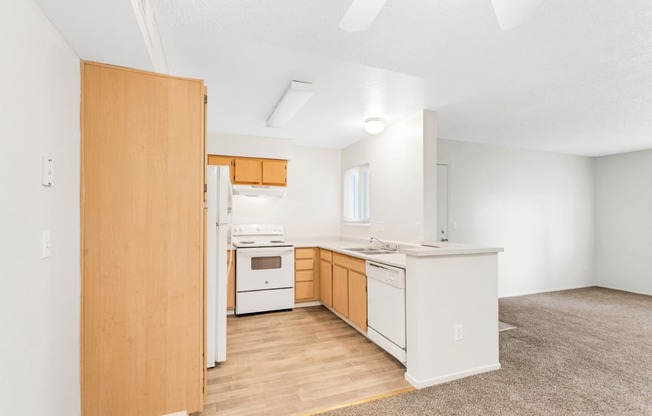 a kitchen with white appliances and wooden cabinets