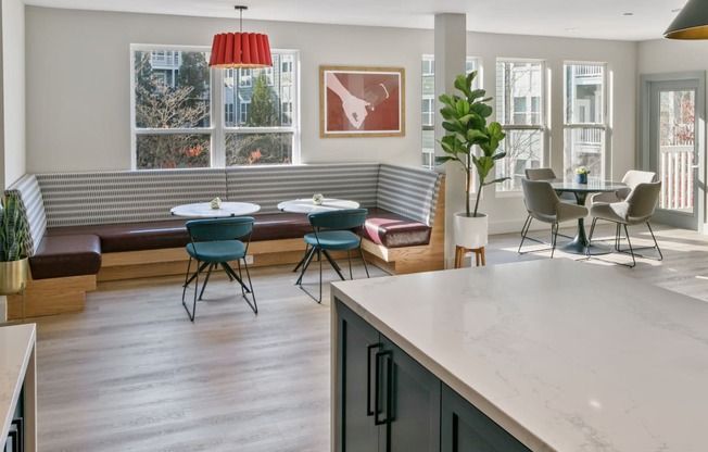 a living room with a table and chairs and a kitchen