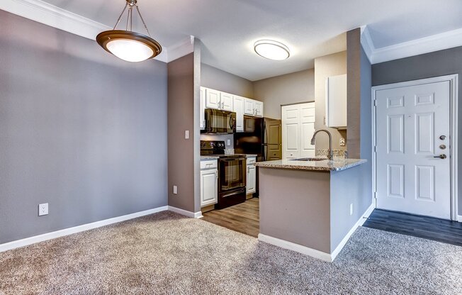 Upgraded kitchen with breakfast bar, granite countertops, black Whirlpool appliances