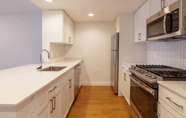 Kitchen with Gas Stove, Stainless Steel Appliances and Quartz Countertops