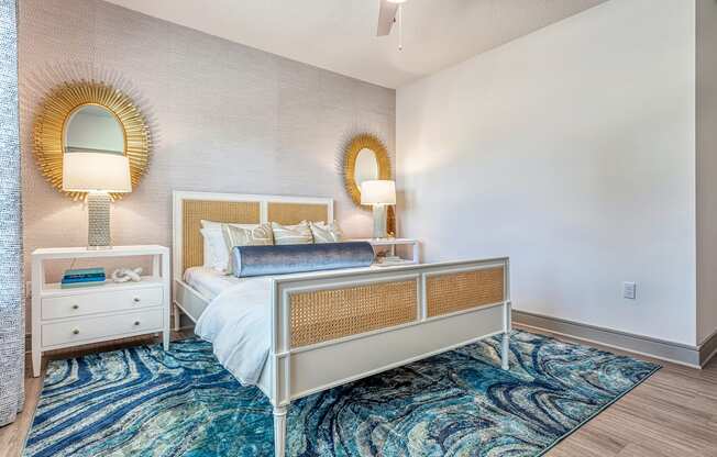 A bedroom with a bed, nightstand, and two lamps.