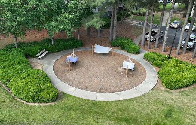 an aerial view of a backyard with a fire pit and a seating area