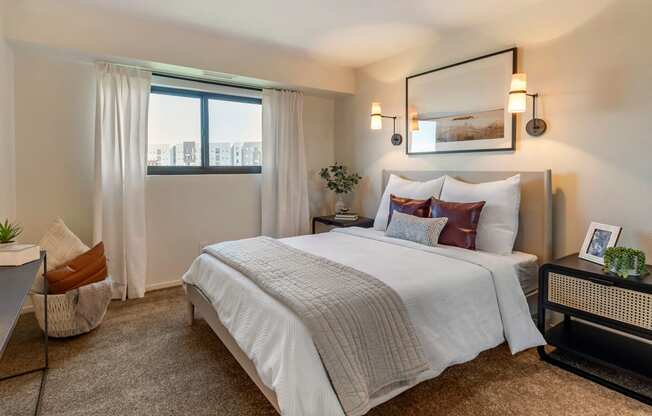 a bedroom with a large bed and a window at The Rays at Vegas Towers Apartments, Las Vegas, Nevada