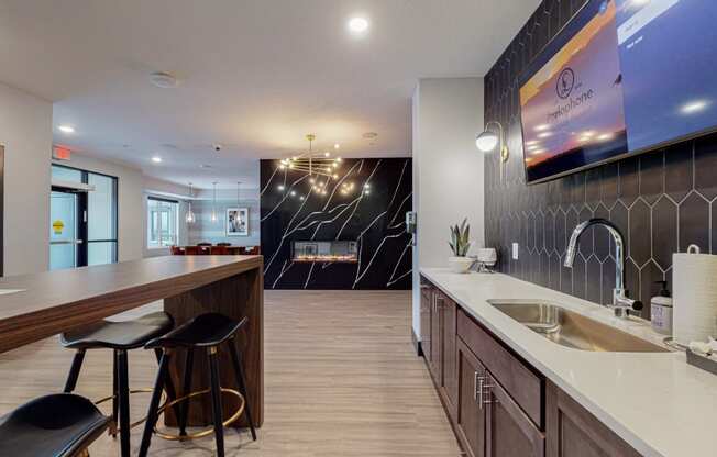 a kitchen with a long counter and stools in front of it
