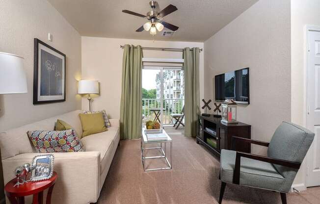 a living room with a couch and a ceiling fan