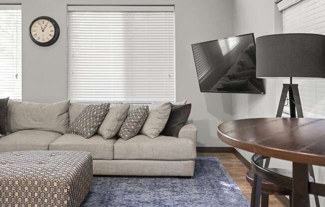 a living room with a couch and a table at Mill Pond Apartments, Auburn