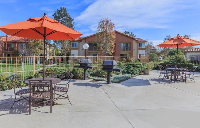 an outdoor patio with tables and chairs and umbrellas at Riverview Springs, Oceanside