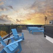 View outside on rooftop lounge with Blue Adirondack Chairs at Arabella Apartment Homes, Shoreline, WA, 98155