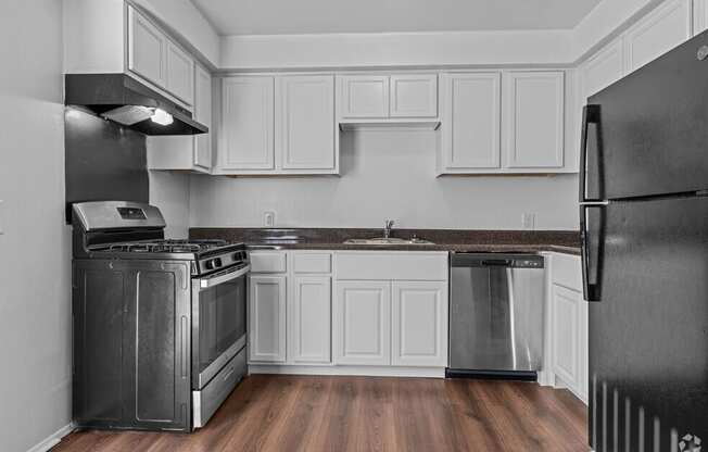 a kitchen with stainless steel appliances and white cabinets