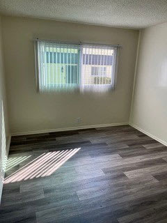 Bedroom with large window at Los Robles Apartments in Pasadena, California.