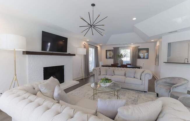 A modern living room with a fireplace and a large sectional sofa.