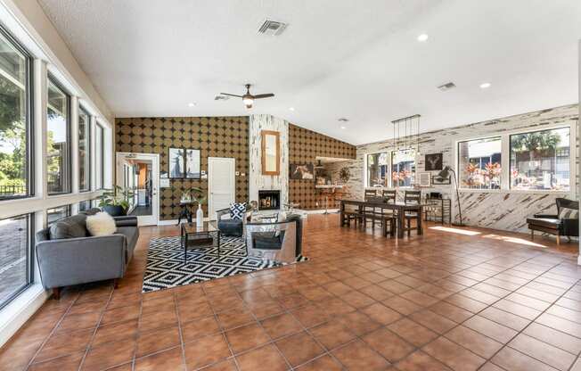 a living room with a fireplace and a table and chairs