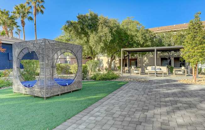 A backyard with a swing set and a patio.