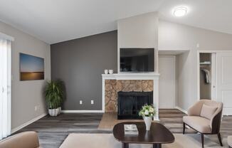 a living room with a fireplace and a tv on the wall