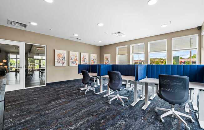 A conference room with a carpeted floor and a long table with chairs.