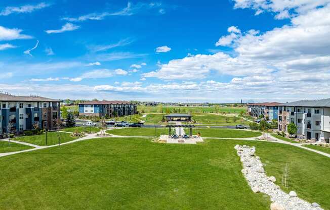 an aerial view of a park with buildings and a fountain at Arbour Commons, Colorado, 80023